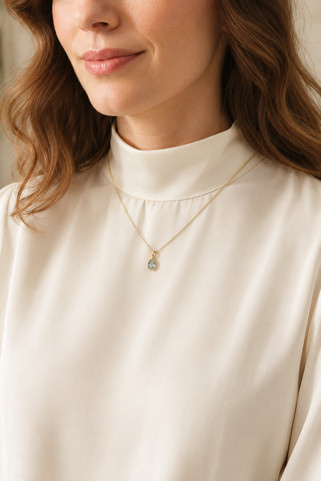 Adult woman wearing Veil Aquamarine Petal Necklace — 14k Gold at approximate scale with modest ivory styling