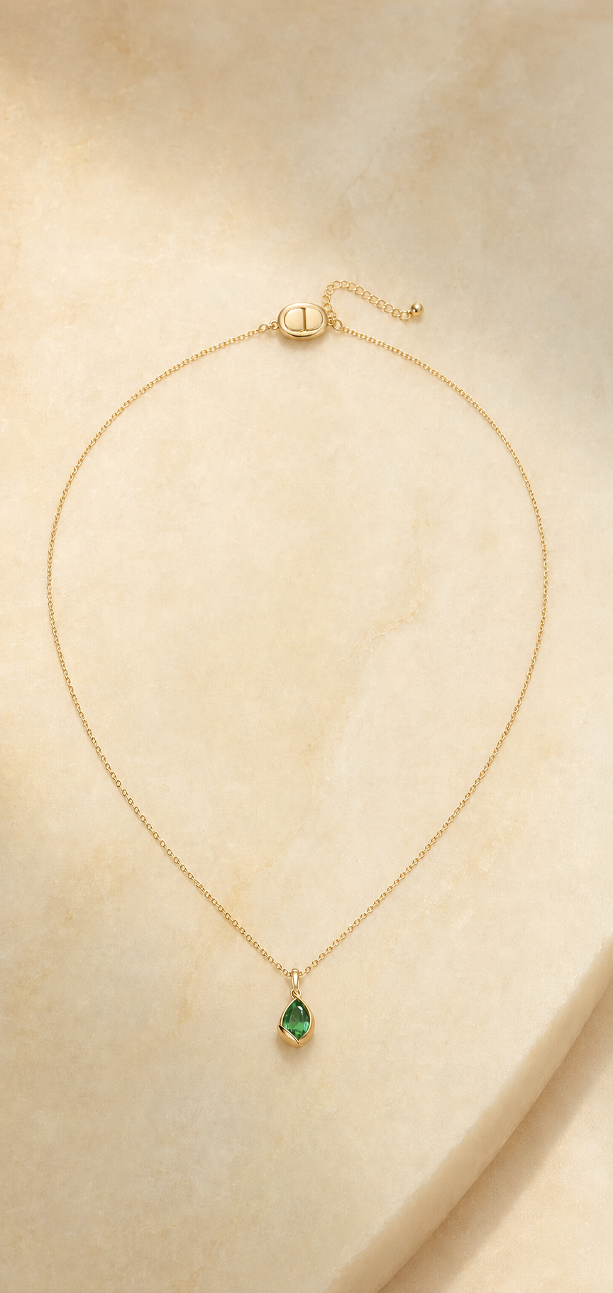 Veil Emerald Dew Necklace — 14k Gold product visualization on warm alabaster