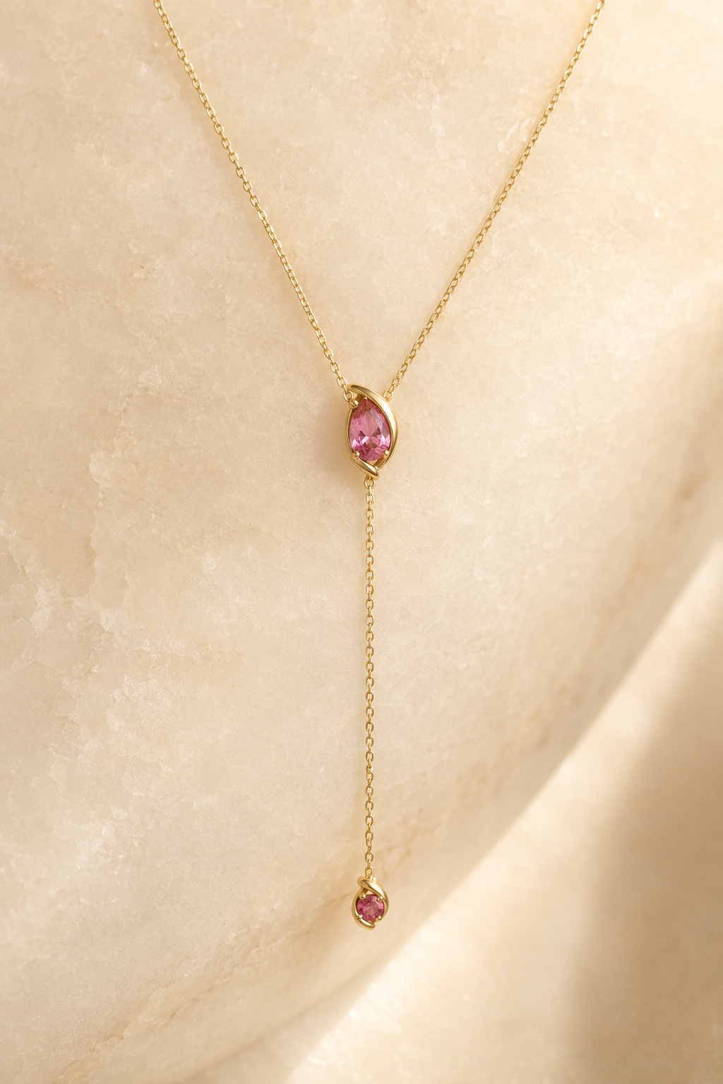 Veil Pink Spinel Lariat — 14k Gold product visualization on warm alabaster