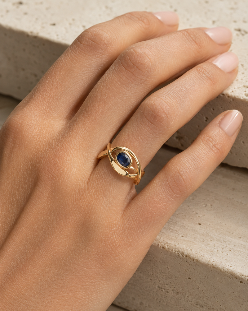 Forgemier Axis Spinner Ring in 14k yellow gold with blue sapphire, shown worn to scale