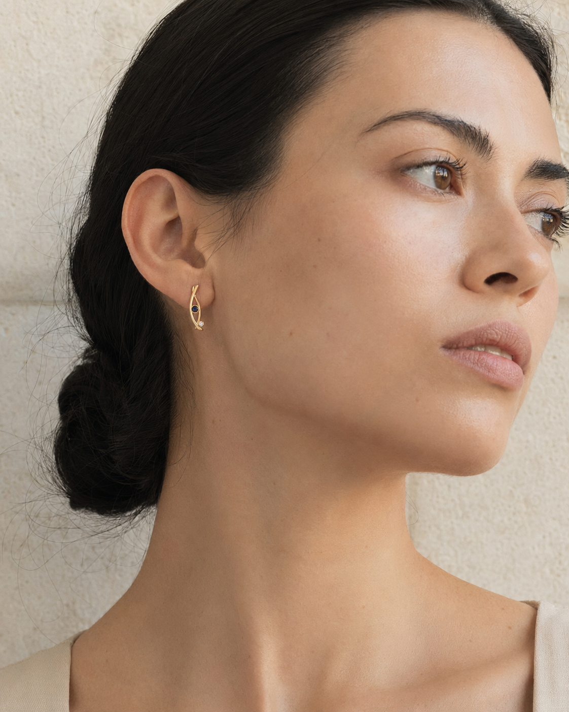 Forgemier Comet Run Earrings in 14k yellow gold with sapphire, shown worn to scale