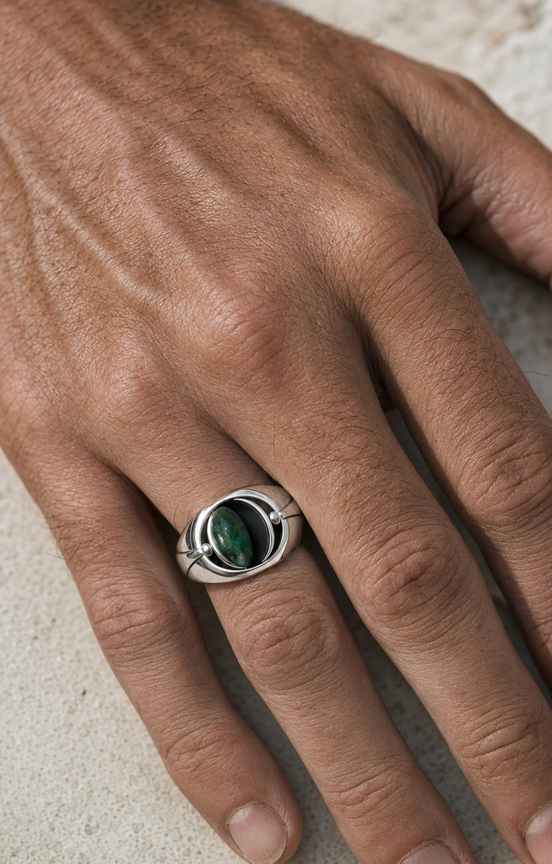 Forgemier Meridian Flip Signet in sterling silver with emerald and black onyx, shown worn to scale