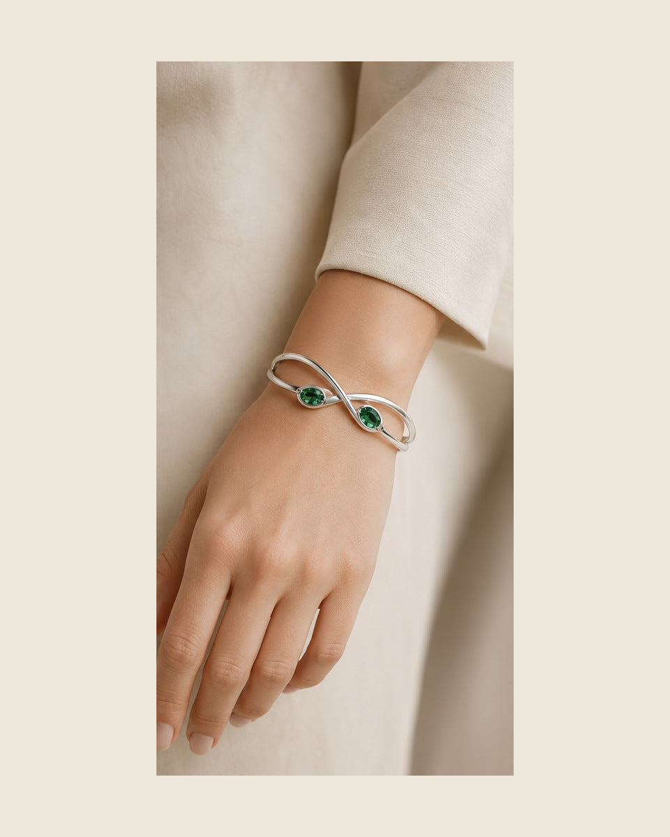 Lilt Forma Cuff — Emerald — shown worn by a woman for scale