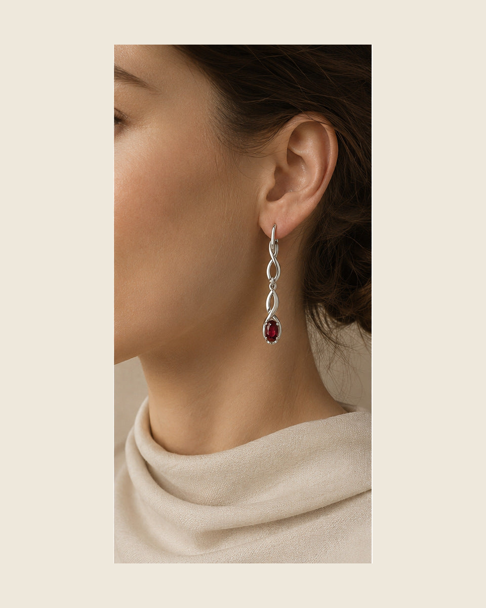 Lilt Forma Drops — Ruby — shown worn by a woman for scale