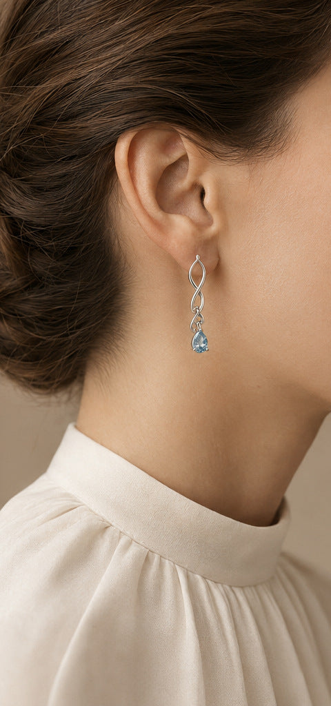Lilt Orbit Drops — Aquamarine — shown worn by a woman for scale