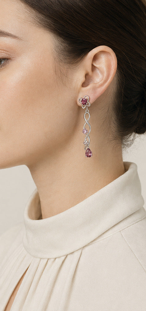Lilt Ribbon Cascade Earrings — Ruby & Pink Spinel — shown worn by a woman for scale